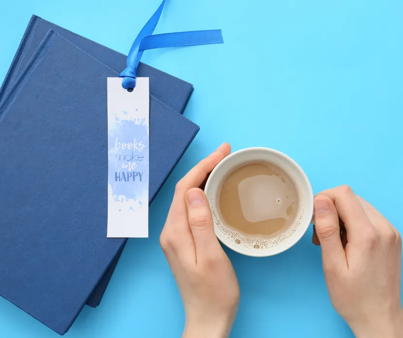 Image for the Books, Brews & Bookmarks event at Georgette's Studio featuring a handmade bookmark, stacked books, and a cup of coffee.